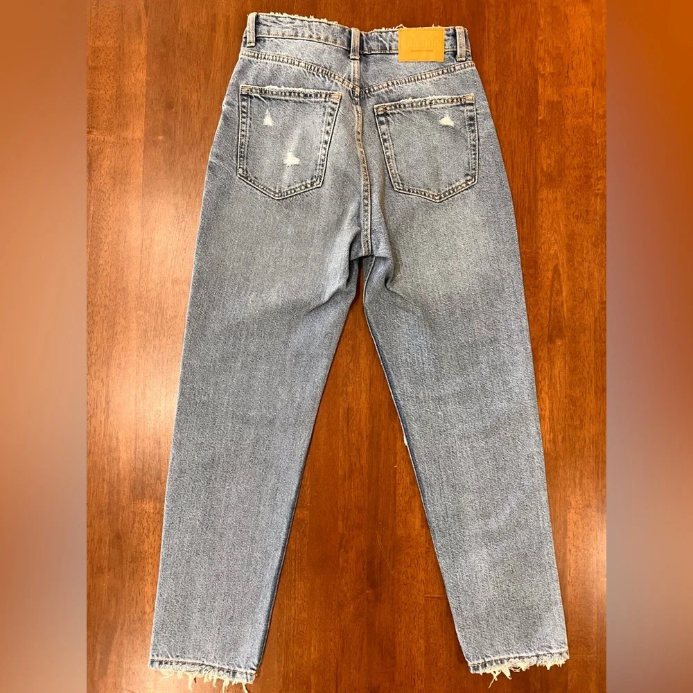 Bershka mom jeans high rise.  with rip in blue. Busted knee Size 4